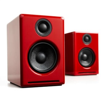 Red speakers with black drivers providing clear and powerful sound