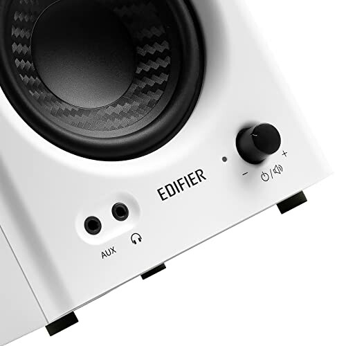 Close-up of a white Edifier speaker with volume control and input ports.