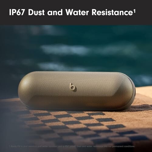 Wireless speaker with IP67 dust and water resistance on a checkered surface.