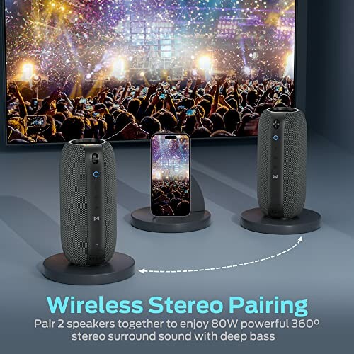 Wireless stereo speakers with phone showing concert on screen.